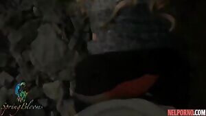 A girl in nature lifts up her black skirt and flashes her tight ass in red panties