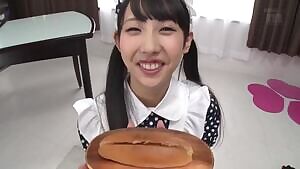 Cute Asian eats a hotdog