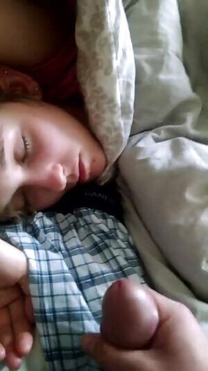 Cumming on her while she were sleeping .